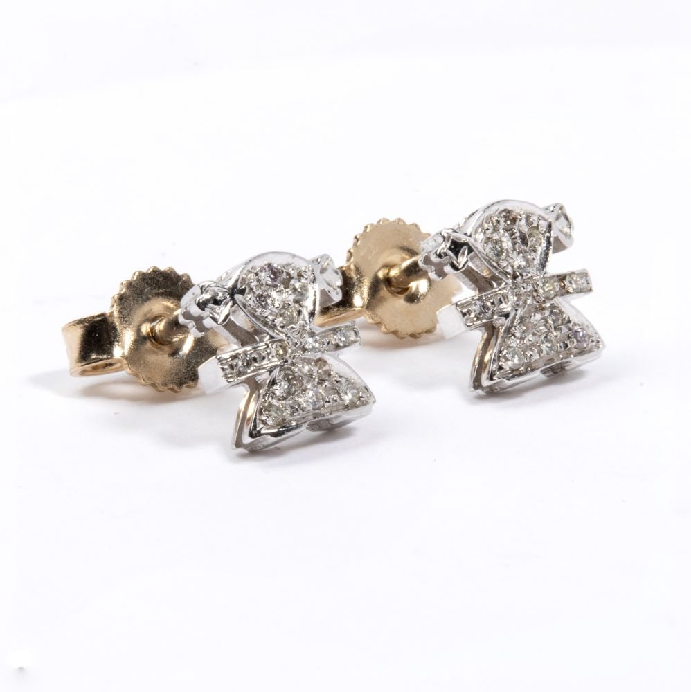 Diamond gold earrings: 18k white gold, featuring the stylised silhouette of a little girl, embellished with a pavé setting of round brilliant-cut diamonds, estimated to weigh a total of approx. 0.07 ct, colour H,