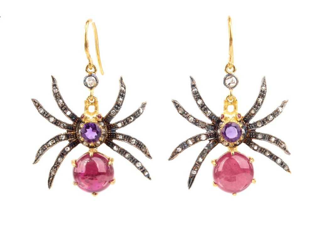 Diamond ruby amethyst pair of drop silver earrings: Each featuring a spider, the body set with a small amethyst and glass-leadtreated ruby and rose-cut diamonds legs. Hallmarked "925". Dimensions: 3.5 x 2.5 cm. Weight: 5.4 g.