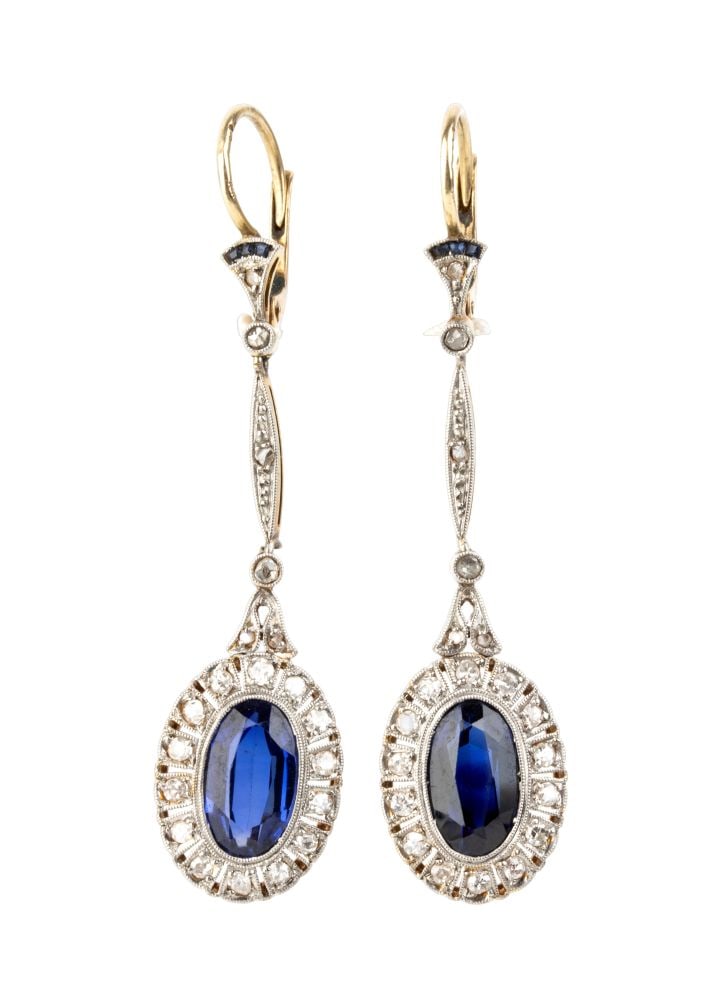 A pair of Art Deco gold and platinum drop earrings with diamonds and synthetic sapphires: Yellow and platinum, each set with a synthetic sapphire surrounded and surmounted by rose-cut and huit-huit-cut diamonds.Length: 4.7 cm. Weight: 4.7 g.