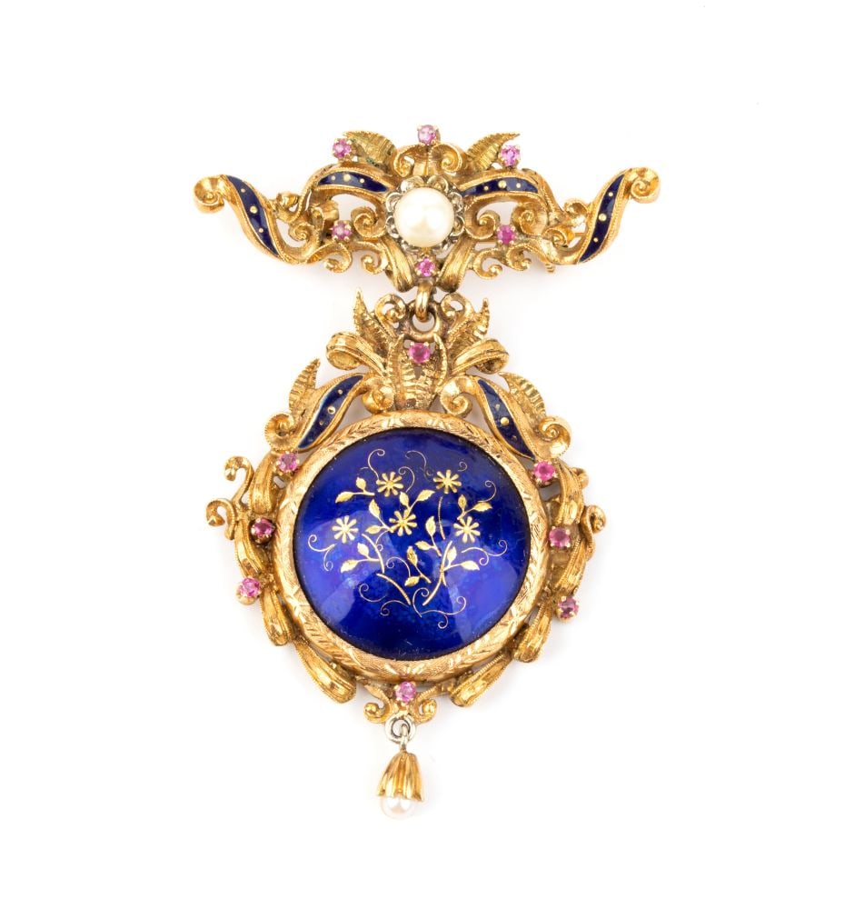 Ruby pearl enamel gold drop brooch: 18k yellow and white gold. The upper section, which acts as a clasp, features a bow motif and interlocking scrolls, with a saltwater cultured pearl at the centre, enamels and ruby details; the
