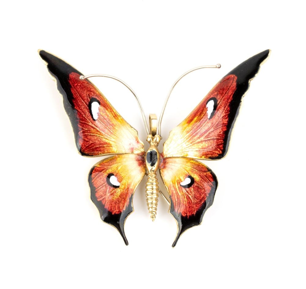 Butterfly enamel gold brooch-pendant: 18k yellow gold, with wings and body decorated with polychrome enamels.Hallmarked "18k - ITALY".Front dimensions: 6.7 x 6 cm. Weight: 19.7 g.