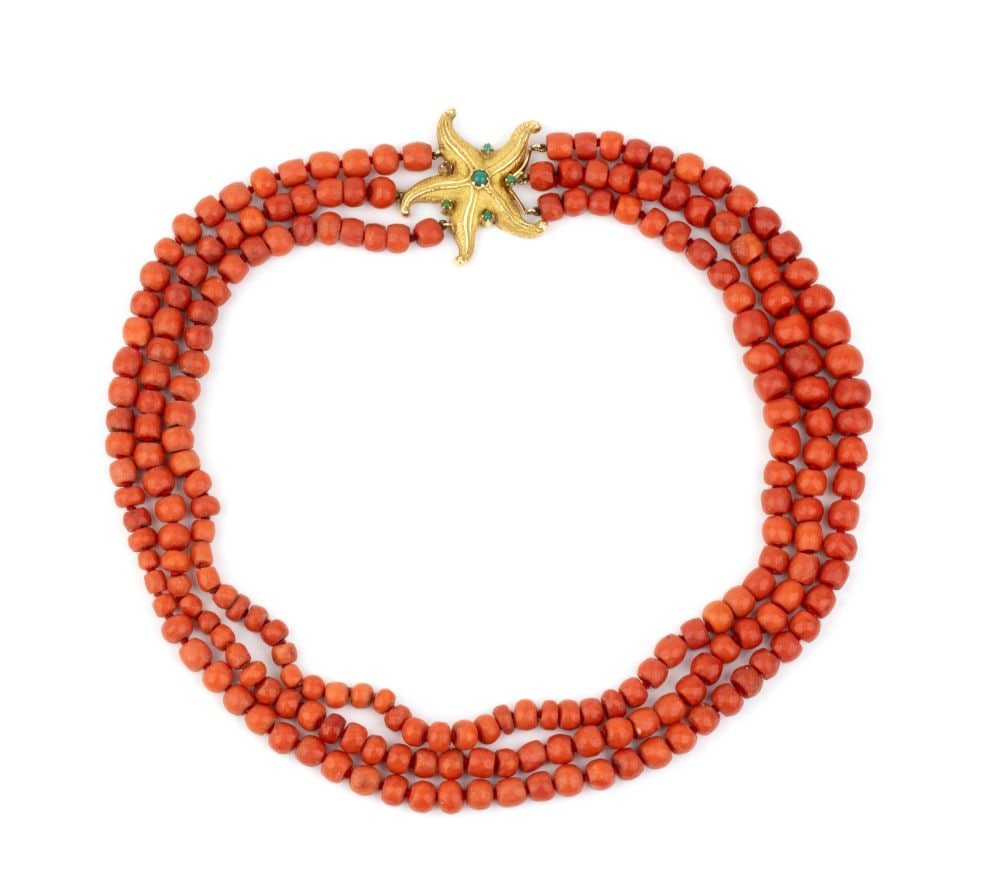 Mediterranean coral necklace with gold star-shaped pendant: One strand of graduated Mediterranean coral faceted barrels (corallium rubrum); 18k yellow gold firmness, depicting a starfish set with chrysoprase cabochons. Hallmarked "750". Corals diameter: from 9