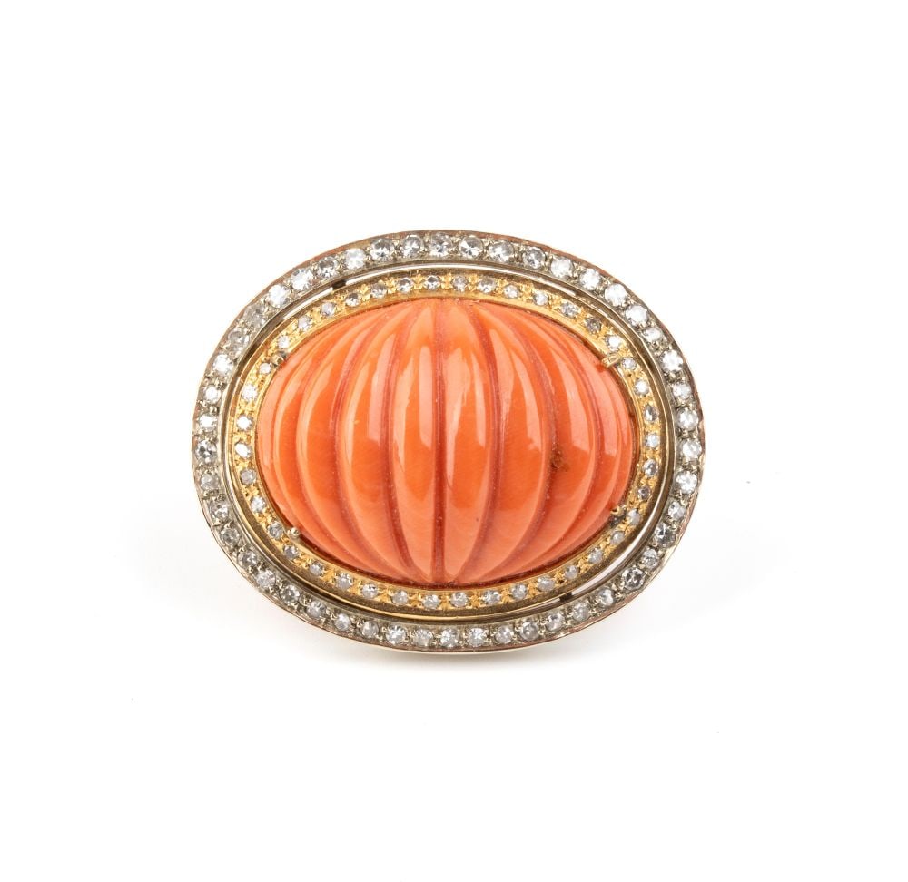 Coral diamond gold brooch: 18k yellow and white gold, oval shaped, set with bombé Cerasuolo coral (Corrallium Elatius) framed by huit-huit-cut diamonds with an estimated total weight of approx. 3.10 ct, color G-I, clarity 
