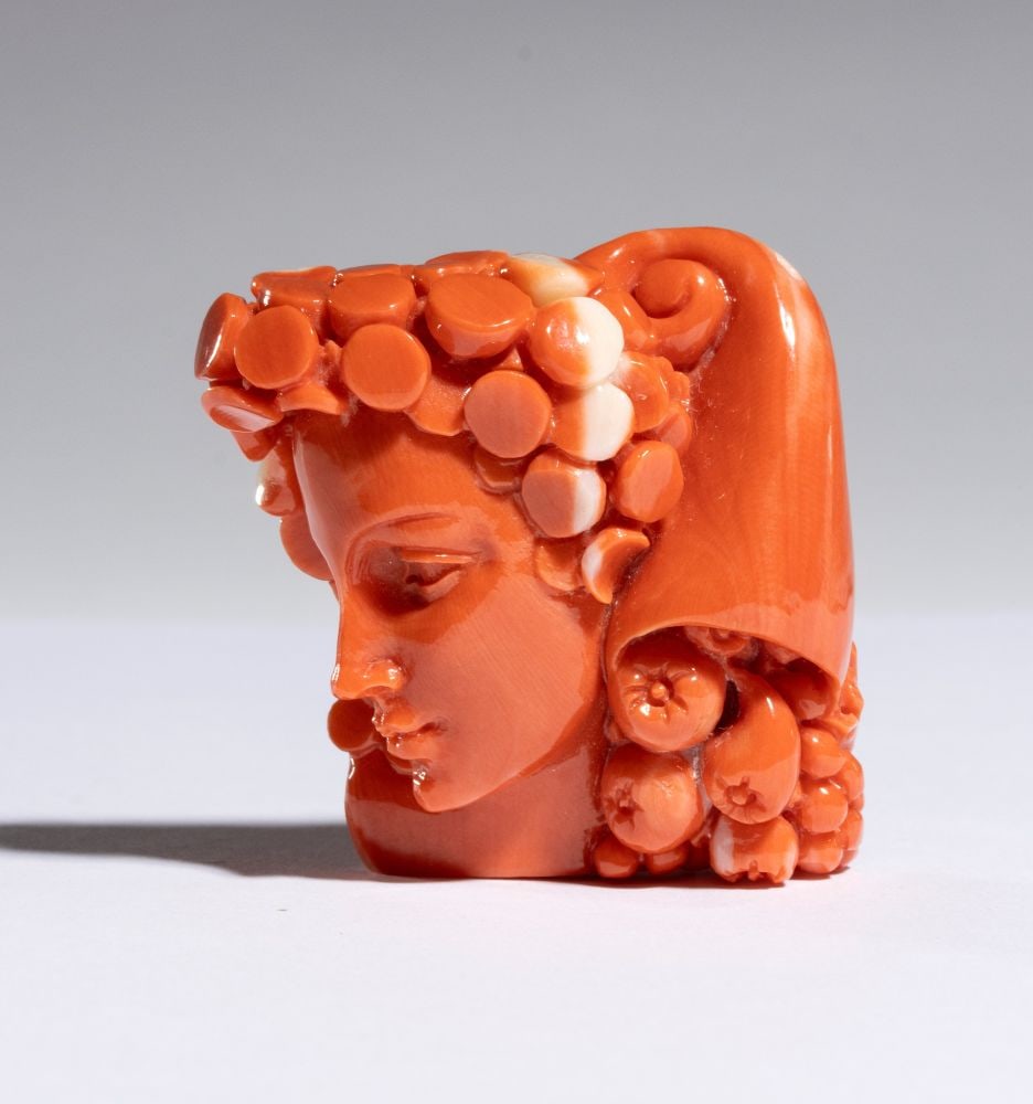 CARLO PARLATI Coral carving depicting an allegorical female figure: Entirely carved from a single branch of Cerasuolo coral (Corallium elatius) of exceptional chromatic quality.The composition depicts a refined female bust in profile, distinguished by idealized featur