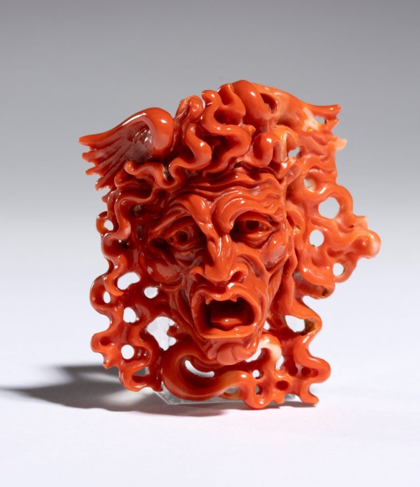 CARLO PARLATI Coral carving depicting the head of Medusa: entirely carved from a single branch of Cerasuolo coral (Corallium elatius) of exceptional chromatic quality.The artist masterfully exploits the coral's natural morphology, transforming it into a