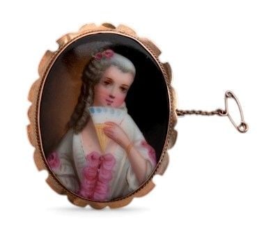 English Victorian gold brooch with porcelain miniature: Hand-painted miniature depicting a lady.Hallmarked “9CT.” Brooch dimensions: 5.3 x 4.4 cm. Weight 13.2 g.