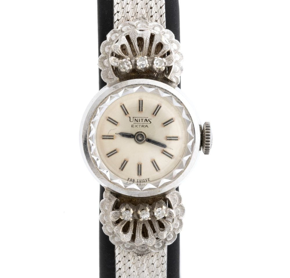 UNITAS 18K gold Lady wristwatch: Case with integrated 18k white gold bracelet set with diamonds, silver-toned dial with baton hour markers, signed UNITA EXTRA. Unitas mechanical movement with manual winding.Comes with original box.Le