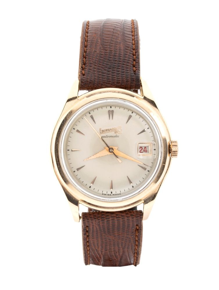 EBERHARD Automatic: wristwatch: With a screw-down case, silver-tone dial with raised hour markers and lettering, and a leather strap. Automatic mechanical movement.Length: 23.5 cm. Case diameter: 37 mm. Gross weight: 45 gr. Gold
