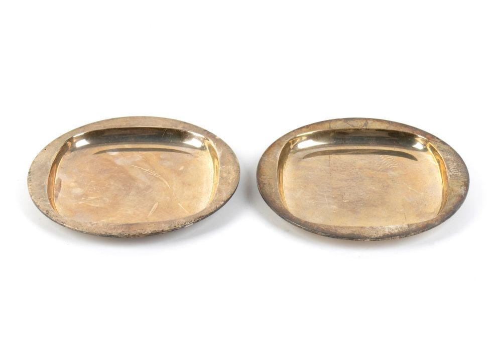 BULGARI A pair of Italian sterling silver saucers: Diameter: 15.5 cm. Total weight: 563 grectangular in shape with rounded corners, characterised by clean, minimalist lines and a low profile.Sterling silver, hallmarked “BVLGARI - 950 - 1971. The