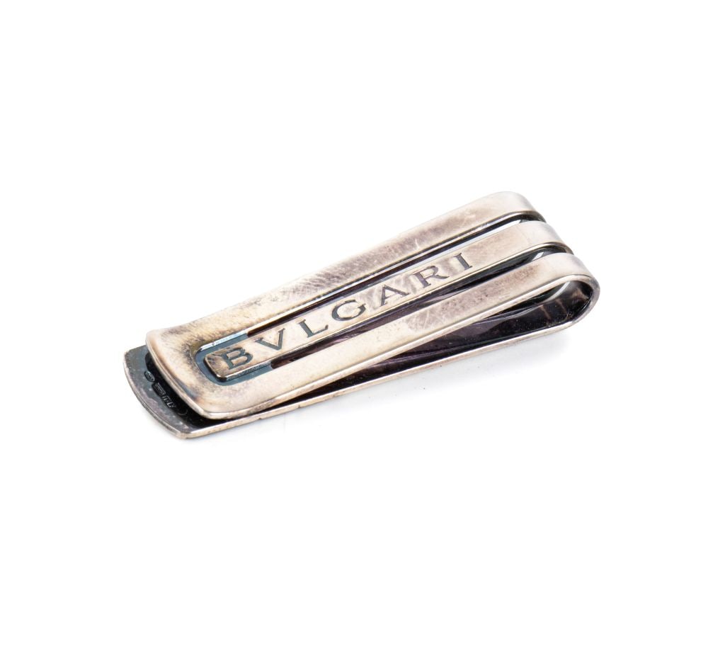 BULGARI Italian Sterling silver money clip: pocket-sized accessory with a modern, compact design. The piece features an elongated rectangular shape with a ‘U’-shaped spring mechanism. The central body is lightened by two perforated 