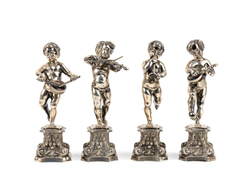 FASSI ARNO Four Italian silver sculptures depicting putti: Total weight: 1218 gdepicts cherubs playing music, standing on a plinth decorated with scroll and leaf motifs. The cherubs are depicted in dynamic poses that suggest the movement of a musical