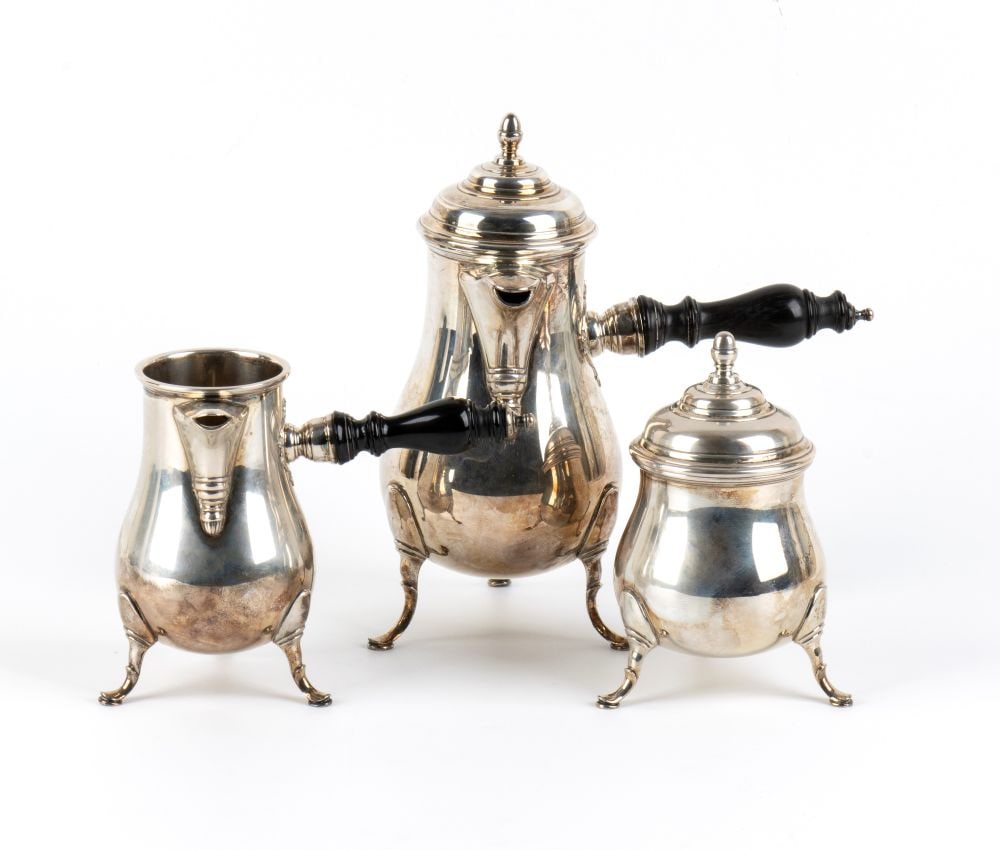 Ricci & C. S.p.A. Italian solid silver coffee set: - Coffee pot: features a rounded, slender body with a long, contoured spout, a hinged lid topped with a spinning-top-style knob, and a side handle in ebonised wood;- Milk jug: features a matching