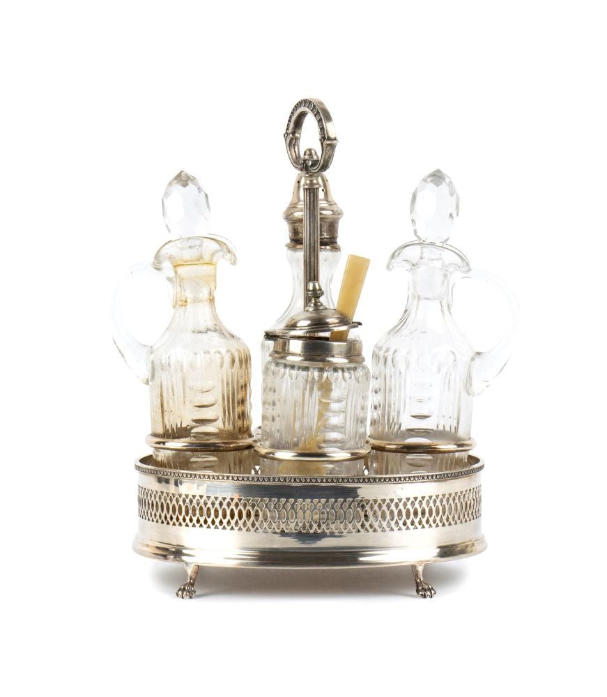 PETRUZZI E BRANCA Italian solid silver cruet set: four bottle cruet on a solid silver base. The base is oval in shape with a high, finely openwork rim featuring a lattice pattern and a top edge decorated with leaf motifs. It rests on four