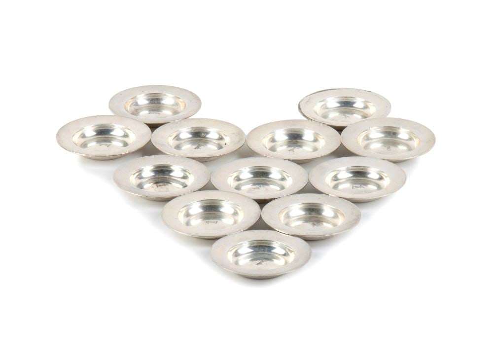 Set of 12 small Italian sterling silver cups: circular in shape with a wide rim. A rampant bear is engraved in the centre of the rim of each saucer.Sterling silver, hallmarked "925 – R. Del Vecchio"
