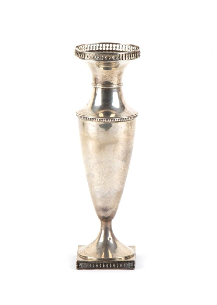 JOSEPH RODGERS & SONS Sterling silver English vase: shaped like a tapered amphora, narrowing towards the bottom and joining a flared neck. The upper rim of the mouth is adorned with an elegant openwork balustrade frieze. The body rests on a foot with a
