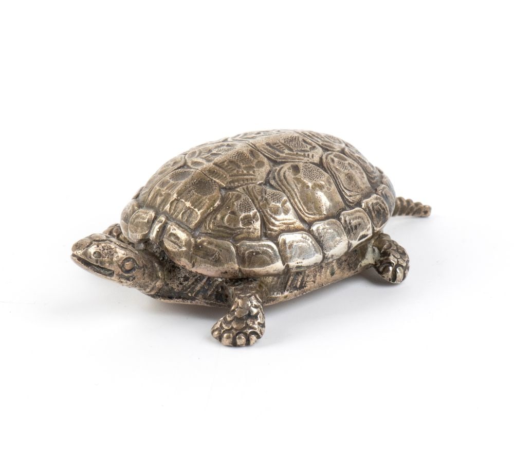 CUSI Italian solidf silver turtle-shaped box: The shell opens up and acts as a snap-on lid, finely engraved with a burin and chiselled to replicate the horny plates. The animal’s body forms the storage compartment, with its legs, tail and
