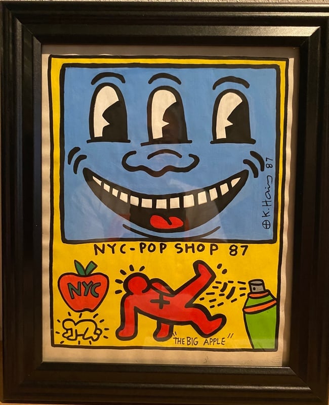 Keith Haring’s “The Big Apple-NY POP SHOP 87 A Poignant Sketch by an Icon: Keith Haring’s “The Big Apple ” NY POP SHOP 87 – A Poignant Sketch by an Icon SIGNED . Approx Painting Size: 10 x 8, Approx New Frame Size: 10 x 12 inches.The technique employed in this co