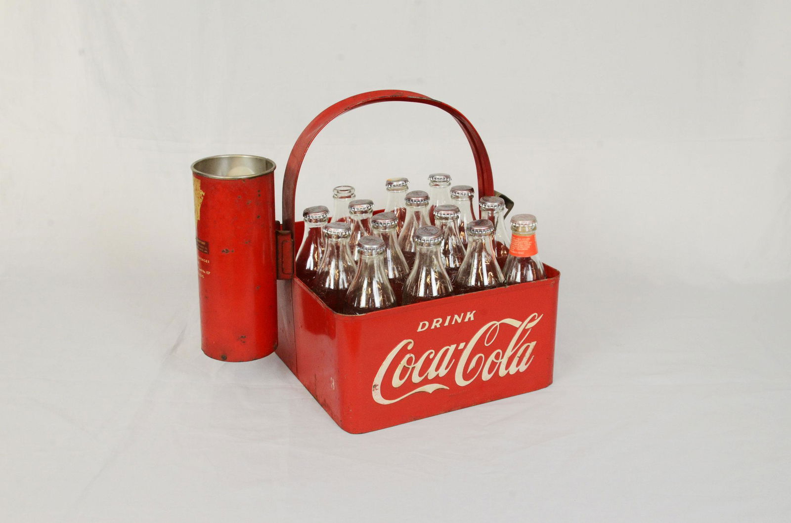 1950's Coca-Cola bottle carrier: 1950's Coca-Cola bottle carrier with bottle opener and inverted Dixie soda cup dispenser. Can fit 20, 25 cl bottles. The bottle opener and bottom is heavily rusted but still holds weight. Good conditi