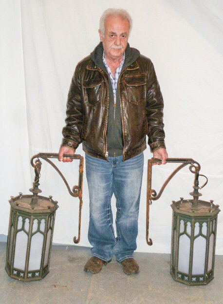 PR GOTHIC BRONZE BUILDING MOUNTED HANGING LIGHTS: SHOWING A PAIR OF GOTHIC BRONZE BUILDING MOUNTED HANGING LIGHTS NICE WEATHERED PATINA, WITH ORIGINAL WROUGHT IRON HANGING BRACKETS SOME RESTORATION IS NEEDED (SEE PHOTOS) . MEASURE 23" LONG AND 12" WI