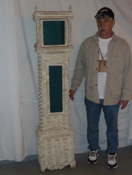 LARGE SIZE 69" TRAMP ART CLOCK CASE WHITE PAINT: SHOWING A LARGE SIZE TRAMP ART CLOCK CASE IN WHITE PAINT . MEASURES 69" TALL BASE MEASURES 16" W BY 12" DEEP .AS FOUND ESTATE CONDITION.PLEASE USE PHOTOS AS PART OF THE DESCRIPTION. THE ABSENCE OF A C