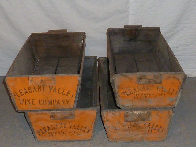 C1900 FOUR WOOD HANDLED BINS PLEASANT VALLEY WINE CO.: SHOWING FOUR CIRCA 1900'S WOOD HANDLED BINS FOR GATHERING GRAPES . DONE IN A SALMON PAINT SIGNED PLEASANT VALLEY WINE CO. MEASURES 31" LONG BY 14 " WIDE AND 7 1/2" HIGH . AS FOUND ESTATE CONDITION.PLE