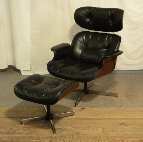 Mid-Century Modern Lounge chair & ottoman: Black leather, bent and laminated wood with chrome . Unsigned Herman Miller , Eames . There are two matching chairs with ottomans in this sale, the other Mid-Century Modern Lounge chair with ottoman i