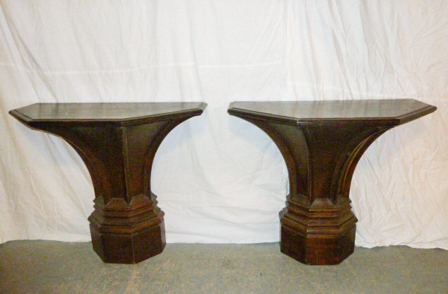 Pair Gothic Style Designer Pedestal Tables: Recessed panels on stepped base. Measures 40" x 36" x 20" . As found estate condition . Please use photos as part of the description. The absence of a condition report does not guarantee excellent con