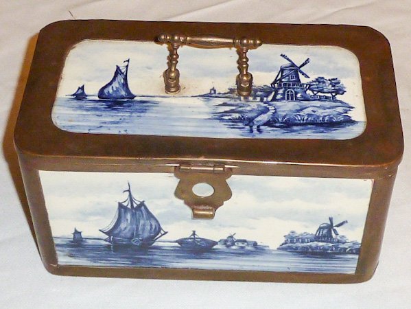 Delft Brass & Blue Tile Covered Box: Windmill and ship motif. Measures 8" wide x 5 5/16" deep and 4" high.As found estate condition . Please use photos as part of the description. The absence of a condition report does not guarantee exce