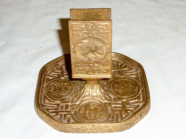Tiffany Bronze Zodiac Ashtray Match Holder: Properly signed on bottom Tiffany studios NY # 1041 . Measures 4" tall on a 4 1/2" ash tray base. As found estate condition . Please use photos as part of the description. The absence of a condition r