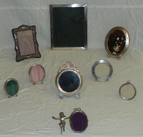 Collection of 9 Sterling Silver Frames: Including a figural Cupid as one of the nine silver frames. Multiple sizes. As found estate condition . Please use photos as part of the description. The absence of a condition report does not guarant