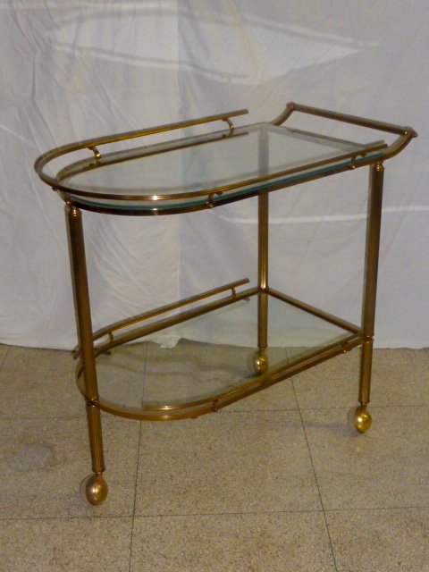 Art Deco Two Tier Rolling Bar /Tea Cart: Stunning ,Gold gilt Brass & Glass with raised sides. Glass shelves. Measures 31 1/4" by 18" and 28 1/2" tall .Bassick Embossed on Wheels As found estate condition . Please use photos as part of the de