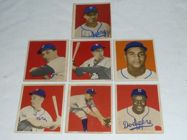 (13) 1949 Bowman Baseball Gum Cards Robinson Etc.: Showing a small collection of thirteen 1949 Bowman Baseball cards together with 14 Promo photos of baseball players. Six have the names of the players on the front: 116. Joe Hatten, 162. Elwin "Preach
