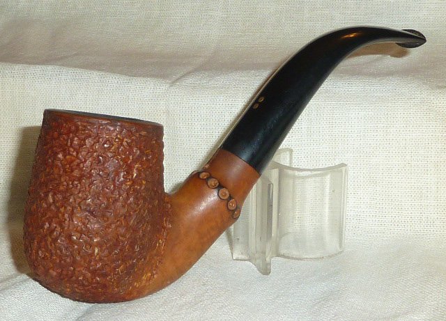 Radice Rind Rusticated Bowl w/ Faux Bamboo Pipe: One of 50 estate pipes in this sale . Measures 5 1/2" . As found estate condition . Please use photos as part of the description. The absence of a condition report does not guarantee excellent conditi