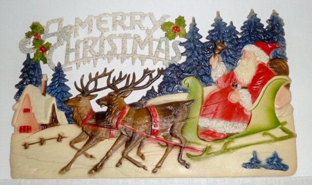 Santa Claus with Reindeer Die-Cut Antique Store Display: Antique Christmas Santa with reindeer Store display. 15” long by 9 1/2” high . Beautiful Image of Old St. Nick in His Sled. Die cut is Heavily Embossed and has Glitter to highlight the Scenes. It 