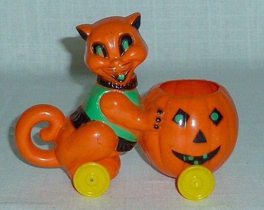 Lg. Rosbro Halloween Cat & Pumpkin Candy Container Toy: Rosbro Rare Large Cat pushing a Pumpkin , Candy Container / Pull toy, in bright Orange. This Halloween Treat measures 6 1/2” in length and Cat is 5” Tall. Pumpkin holds Candy and toy has wheels. C