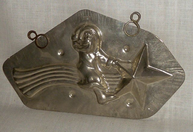 Antique Santa Riding a Shooting Star Chocolate Mold: Antique Santa Claus Chocolate Mold. Scarce Image of Santa riding a shooting Star. Mold has clips. Made in France. Measures 9 1/2” long by 5 1/2” high. As found estate condition . Please use photos