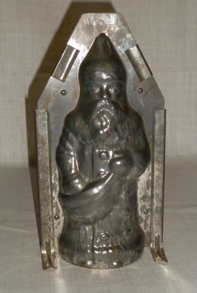 1900's Scarce Christmas Santa Chocolate Mold Germany: Santa Antique Metal Chocolate Mold . Santa Mold Stands 10” tall. Has all its Clips . Marked Ges. Gesch. Scarce Santa Mold. Clean an intact. As found estate condition . Please use photos as part of t