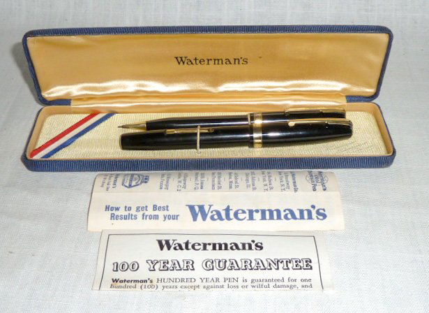 Waterman's 100 yr Fountain Pen & Pencil Set: Waterman's Ideal logo on the side of both barrels . Point is clean and appears to be unused. 100 yr logo on point. Comes with original box, and paperwork , minor wear to band and clip. Pen is 5" close