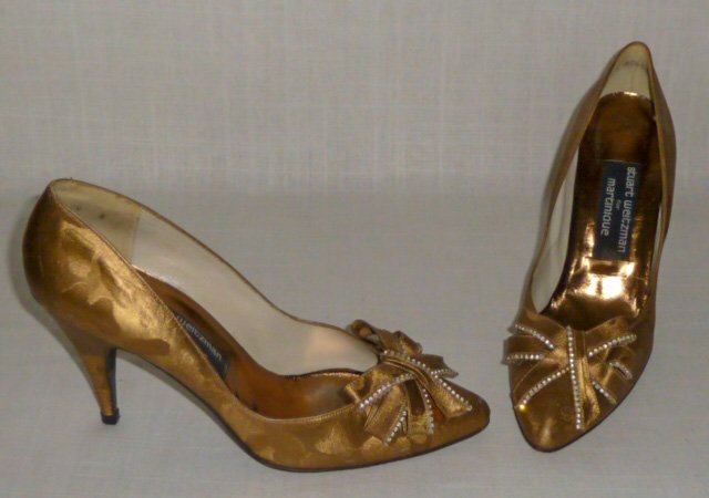 Vintage Stuart Weitzman Gold Lame: Stuart Weizman exquisite vintage classic woman's high heels. Shoe is a gold textured leather from 4” high heel to tip of Ribboned and Rhinestone Toe. Shoes are stamped on leather sole Â“Stuart We