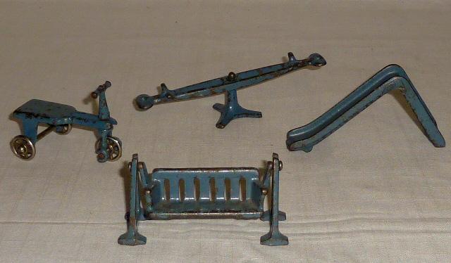 Kilgore Cast Iron 4 Piece Toy Play Set: Kilgore Antique Cast Iron Toy Set. This set consists of four Playground sets: Slide 4”, See-Saw 5 1/2”, Scooter 3”, and glider 3 1/2”. Very unusual set in a Fabulous Blue Paint
