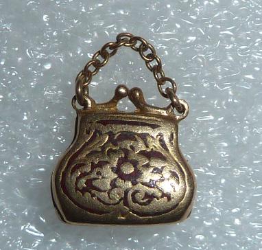 14 Kt Gold Antique Movable Purse Charm: 14kt. Gold Purse Charm. Weight is 1.9dwt and measures 3/4” by 1/2”. Purse opens, As found estate condition . Please use photos as part of the description. The absence of a condition report
