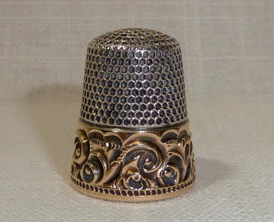 14kt Gold & Sterling Silver Antique Sewing Thimble: 14kt Gold and Sterling Silver Antique Sewing Thimble . Thimble Is Heavy Sterling Silver with a wide beautifully embossed 14kt Gold band. Band is marked 14kt and inside is marked Sterling with a makers