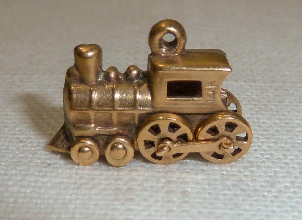 14kt Gold 3D Articulate Movable Train Locomotive Charm: "All Aboard" This Steam Engine Train with movable wheels measures 3/4” long and weighs in at 1.5 dwt. Don't be left at the station, get onboard. As found estate condition . Please use photos as part