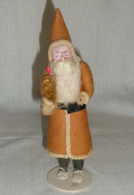 Christmas St. Nick Santa Figural Candy Container: Wonderful Example of an early Holiday Santa Candy Container. Santa is a full bodied Figure dressed including hood and holding Tree. Legs come off and his body is filled with Holiday treats. St Nick or