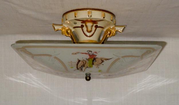 Porcelain Cowboy Lighting Fixture With Original Shade: Vintage cowboy Ceiling Fixture with Original Shade, Fixture Has Pure Cowboy Imagery with Guns and Steer Designs both on Base and Shade . Ceramic Base measures 7 ½ “ high by 6 “ around