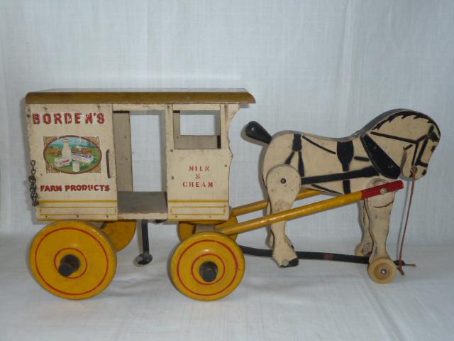 1930's Rich Toys Borden's Farm Products Pull Toy: Vintage Borden's Farm Products Toy, milk and cream delivery horse and wagon pull toy. This large Borden's wagon pull toy measures 24" long by 12 3/4" tall and 9 3/4" wide. Shows play wear and tear con
