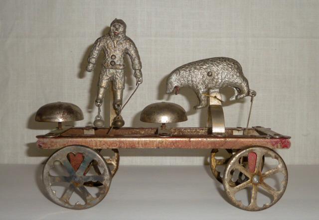 Watrous Rare 1890 Eskimo and Polar Bear Large Bell Toy: This Watrous Example of the Eskimo and Polar bear Bell Toy is very Scarce and Rare. It Dates to 1890 . Made of Iron it measures 10 “ by 8 “ to top of Eskimo . Some work to wheels. Made by