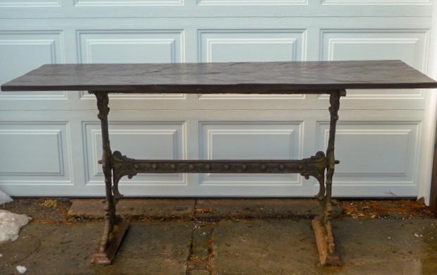 Art Nouveau Cast Iron & Black Slate Console Table: Art Nouveau cast iron console table has an ornate base and black slate top. Measures 64 1/2” wide by 22 1/2” deep and 30 3/4” tall. Base measures 42” wide by 17 1/4” deep. They way you want 