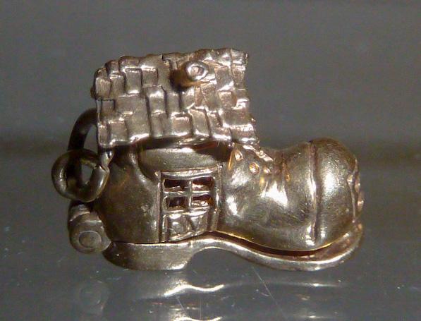 14kt Old Woman In The Shoe 3D Movable Articulate Charm: Based on the famous Mother Goose nursery rhyme . This adorable charm features a detailed engraved boot complete with a roof and cut-out windows.The top of shoe opens to reveal her family. What a Gem&#