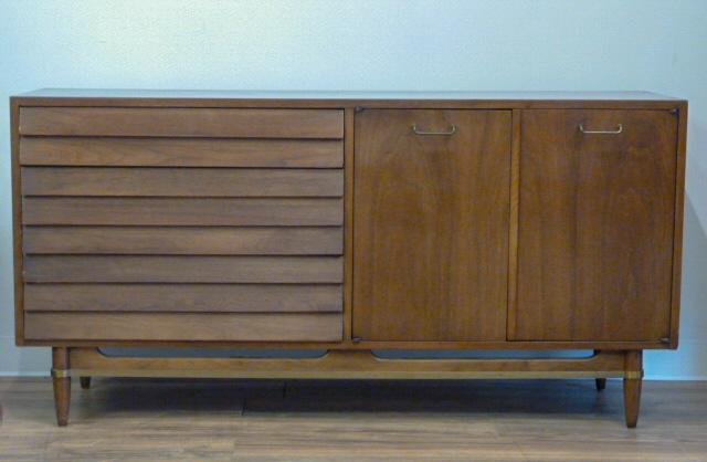 Mid-Century Louvered Credenza American of Martinsville: Beautiful warm , rich walnut wood grain with louvered front , designed by Merton L. Gershun for the Dania collection . American , mid-century modern with brass banding and puls. This buffet/credenza i